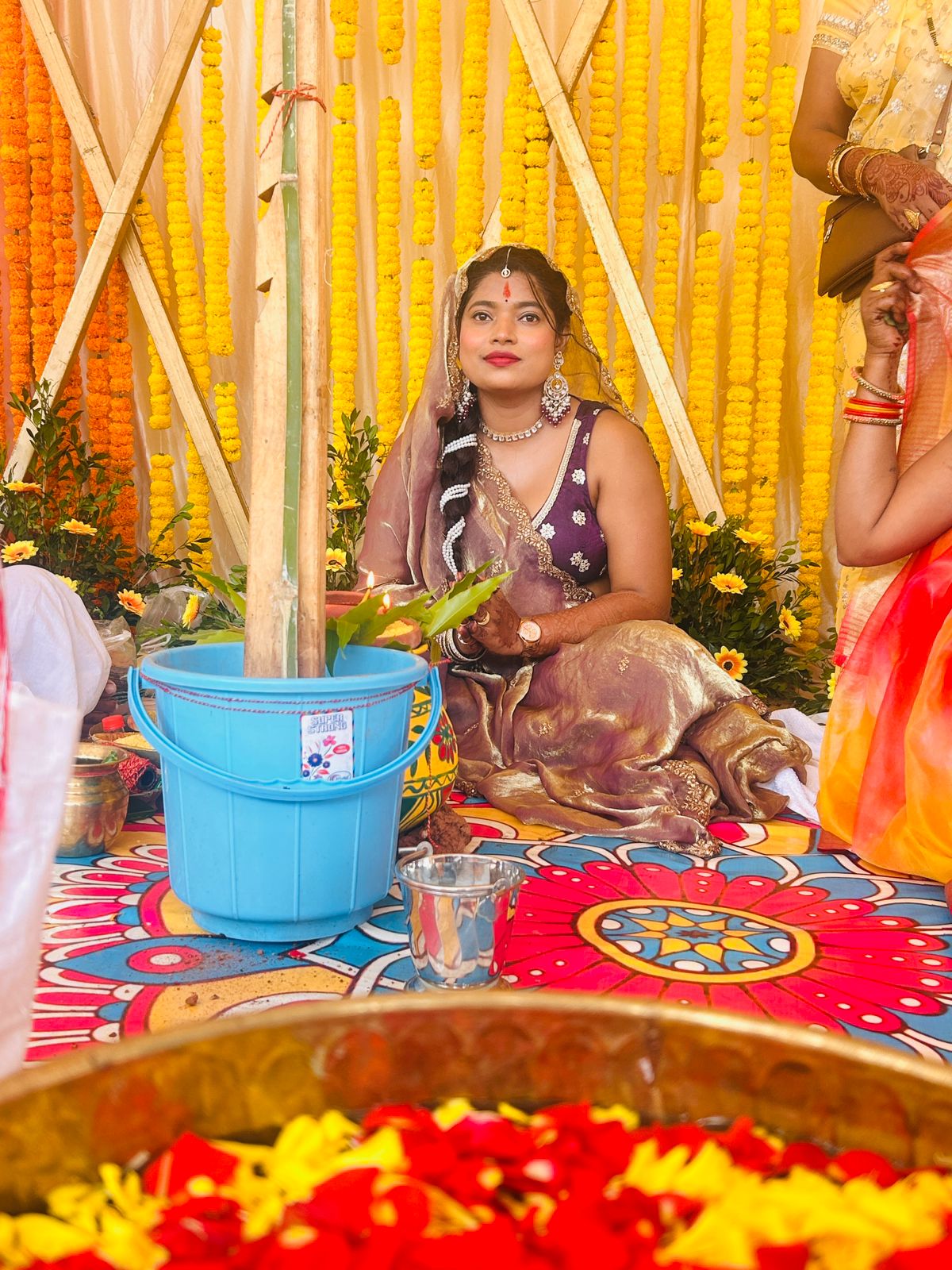 Nishtha after breast reduction - at wedding ceremony in purple saree with bridal jewellery and marigold decor