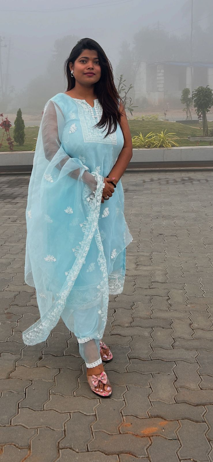 Nishtha before breast reduction - front view in light blue chikankari kurta on a misty day
